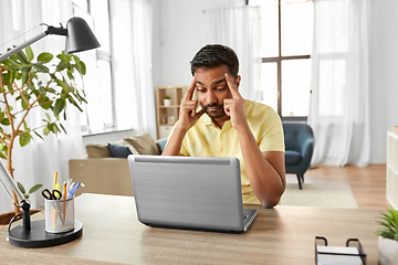 Image showing indian man with laptop working at home office