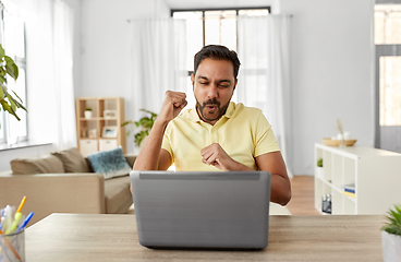 Image showing indian man with laptop working at home office