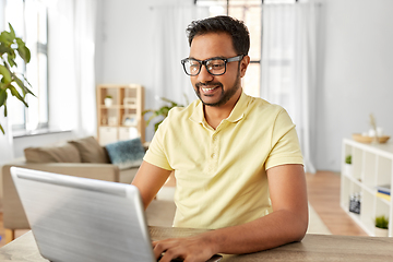 Image showing indian man with laptop working at home office