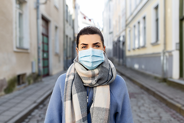 Image showing woman wearing protective medical mask in city