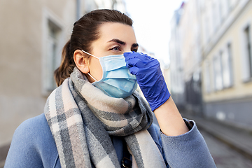 Image showing woman wearing protective medical mask in city