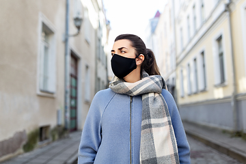 Image showing woman wearing protective reusable mask in city