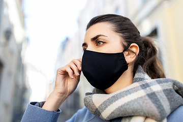 Image showing woman wearing protective reusable mask in city