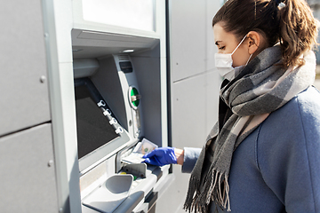 Image showing woman in medical mask and glove with money at atm