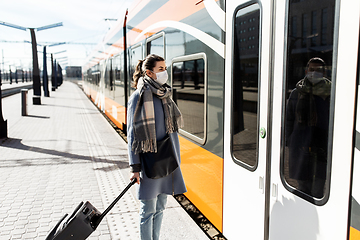 Image showing woman in protective face mask at railway station