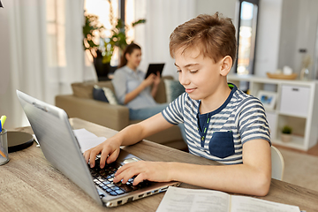 Image showing student boy with laptop learning at home