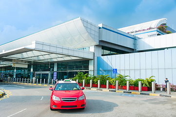 Image showing Taxi cab by airport terminal