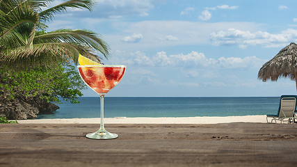 Image showing Summer refreshing cocktail with sea or ocean beach on background