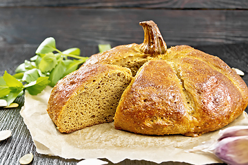 Image showing Bread pumpkin cut on a dark board