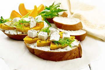 Image showing Bruschetta with pumpkin and ricotta on white board