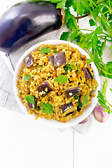 Image showing Bulgur with eggplant in bowl on light board top