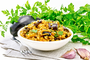 Image showing Bulgur with eggplant in bowl on wooden board