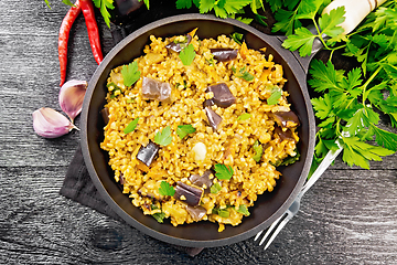 Image showing Bulgur with eggplant in pan on board top