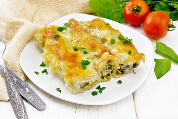 Image showing Cannelloni with curd and spinach in plate on light board