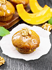 Image showing Cupcake pumpkin with orange glaze and walnuts on paper