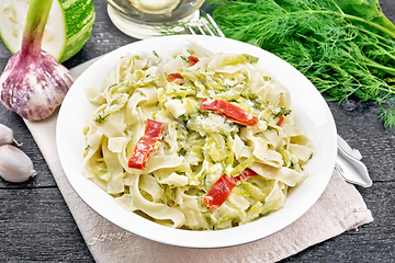 Image showing Fettuccine with zucchini and hot peppers in plate on napkin