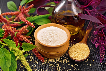 Image showing Flour amaranth in bowl and oil on dark board