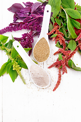 Image showing Flour and seeds amaranth in spoons on board top