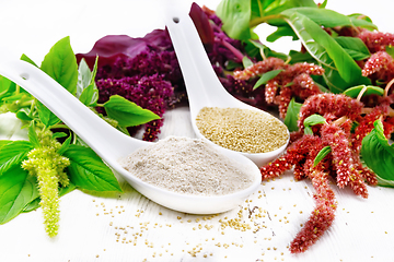 Image showing Flour and seeds amaranth in spoons on wooden board