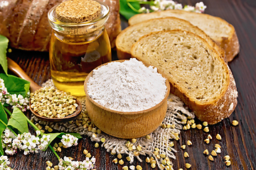 Image showing Flour buckwheat green in bowl with bread on dark board