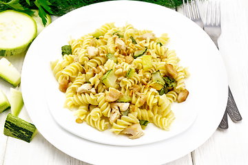 Image showing Fusilli with chicken and zucchini in two plates on white board