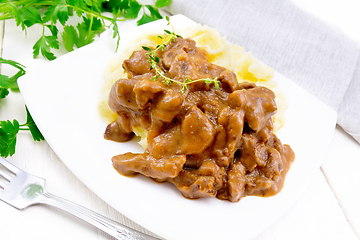 Image showing Goulash of beef with mashed potatoes in plate on board
