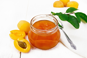 Image showing Jam apricot in jar on light board