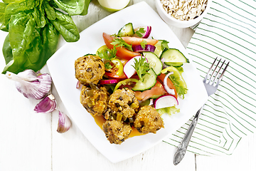 Image showing Meatballs with spinach and oatmeal on board top