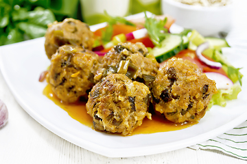 Image showing Meatballs with spinach and oatmeal on board