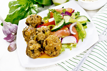 Image showing Meatballs with spinach and oatmeal on light board