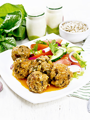 Image showing Meatballs with spinach and oatmeal on table