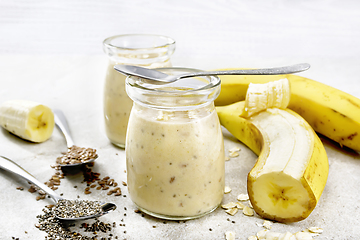 Image showing Milkshake with chia and banana in two jars on stone table