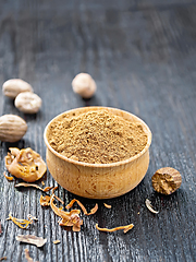 Image showing Nutmeg ground in bowl on black wooden board