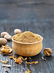 Image showing Nutmeg ground in bowl on dark board