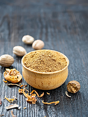 Image showing Nutmeg ground in bowl on dark wooden board