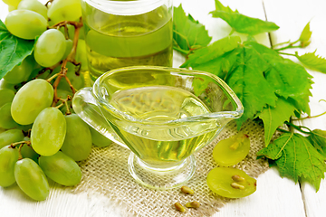 Image showing Oil grape in gravy boat on white board