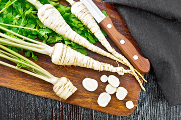 Image showing Parsley root chopped with knife on dark board top