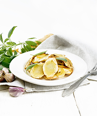 Image showing Parsnips baked in plate on wooden board