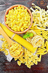 Image showing Pasta different with basil on dark board top