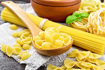 Image showing Pasta different with basil on wooden board