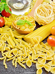 Image showing Pasta different with oil and tomatoes on board