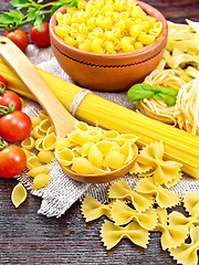 Image showing Pasta different with tomatoes on wooden board