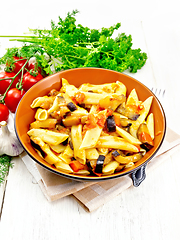 Image showing Pasta penne with eggplant and tomatoes on wooden board