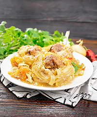 Image showing Pasta with meatballs in plate on napkin