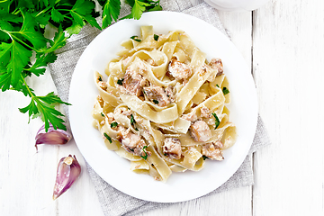 Image showing Pasta with salmon and cream on board top