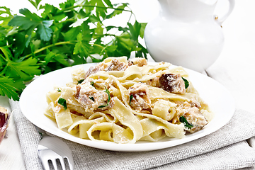 Image showing Pasta with salmon and cream on board