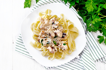 Image showing Pasta with salmon in cream on light board top