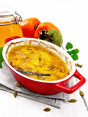 Image showing Persimmons baked with honey in pan on table