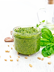 Image showing Pesto in glass jar on light board