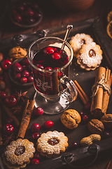 Image showing Mulled wine with cranberry and spices, Christmas cookies and candles